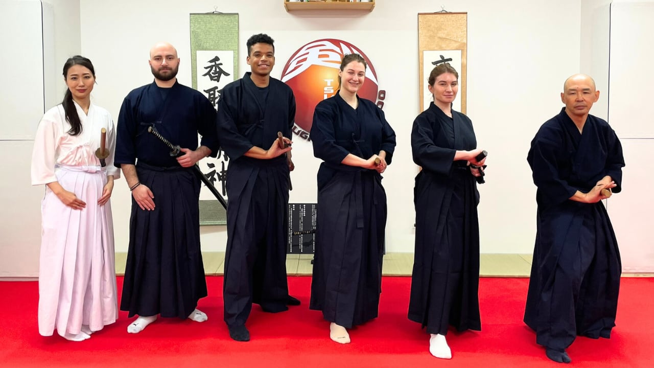 A group practicing wooden-sword techniques